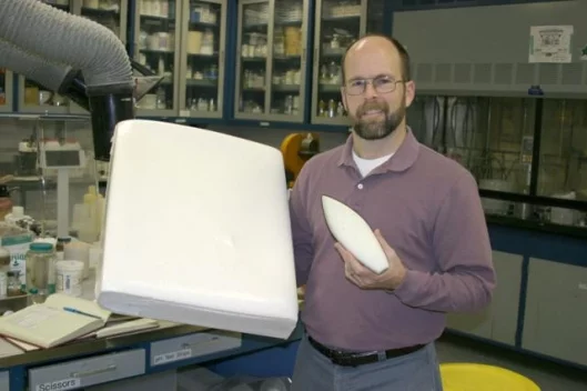 Sandia materials researcher LeRoy Whinnery poses with two TufFoam samples. Originally created for the National Nuclear Security Administration (NNSA) to protect sensitive electronic and mechanical structures from harsh environments, the foam’s properties