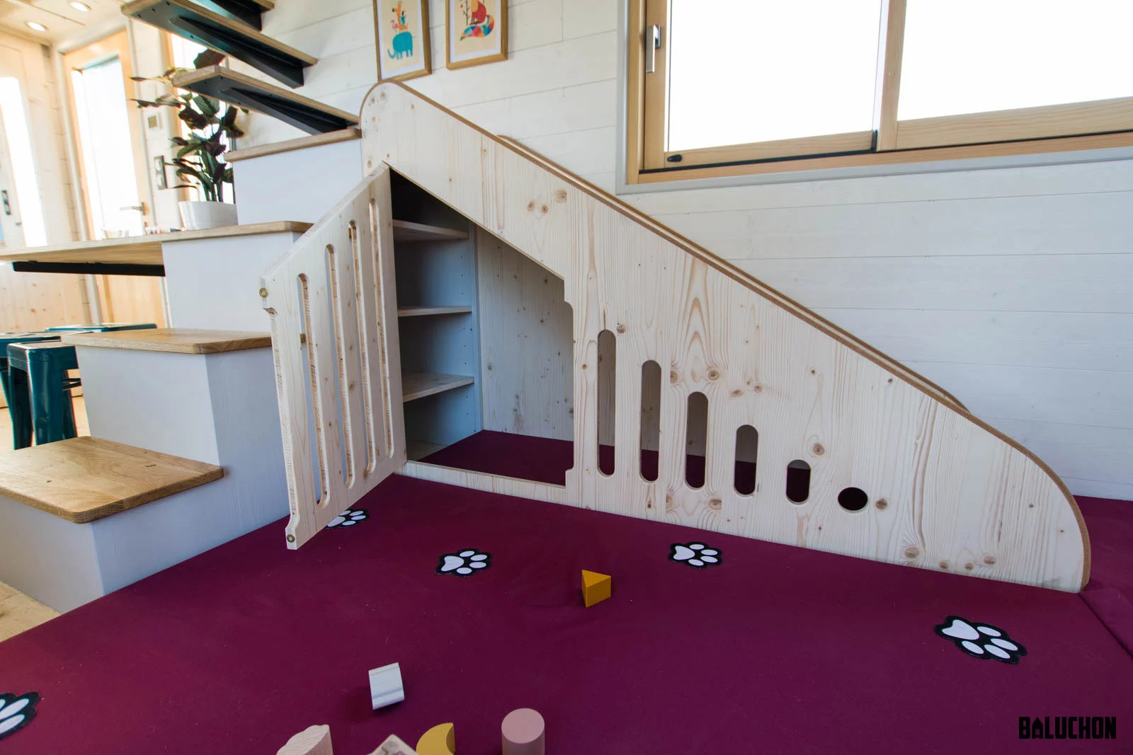 La Maison du Bonheur's slide features a small playhouse area below