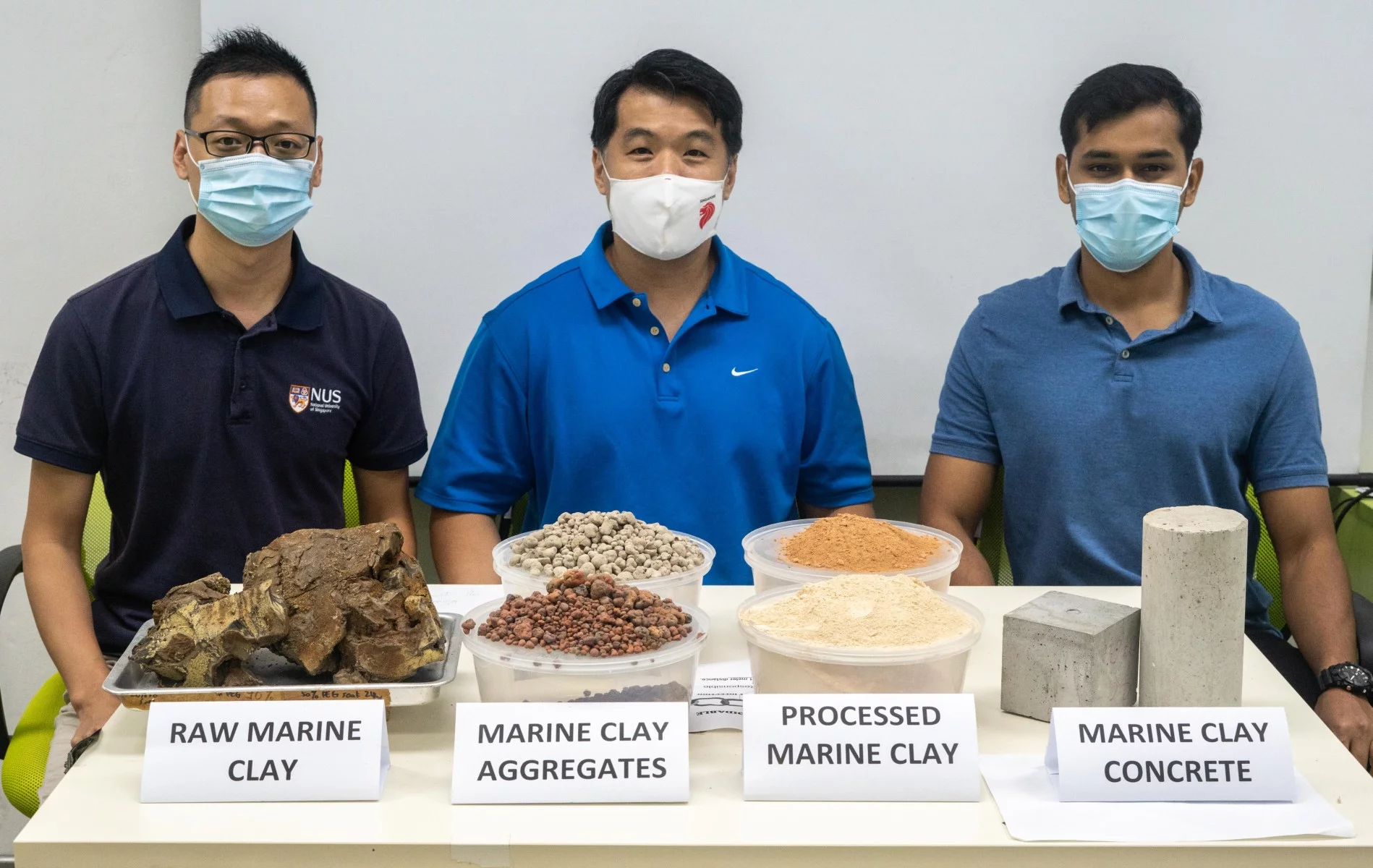 Researchers from the National University of Singapore' Centre for Advanced Materials with samples of their eco-friendly concrete that incorporates waste clay