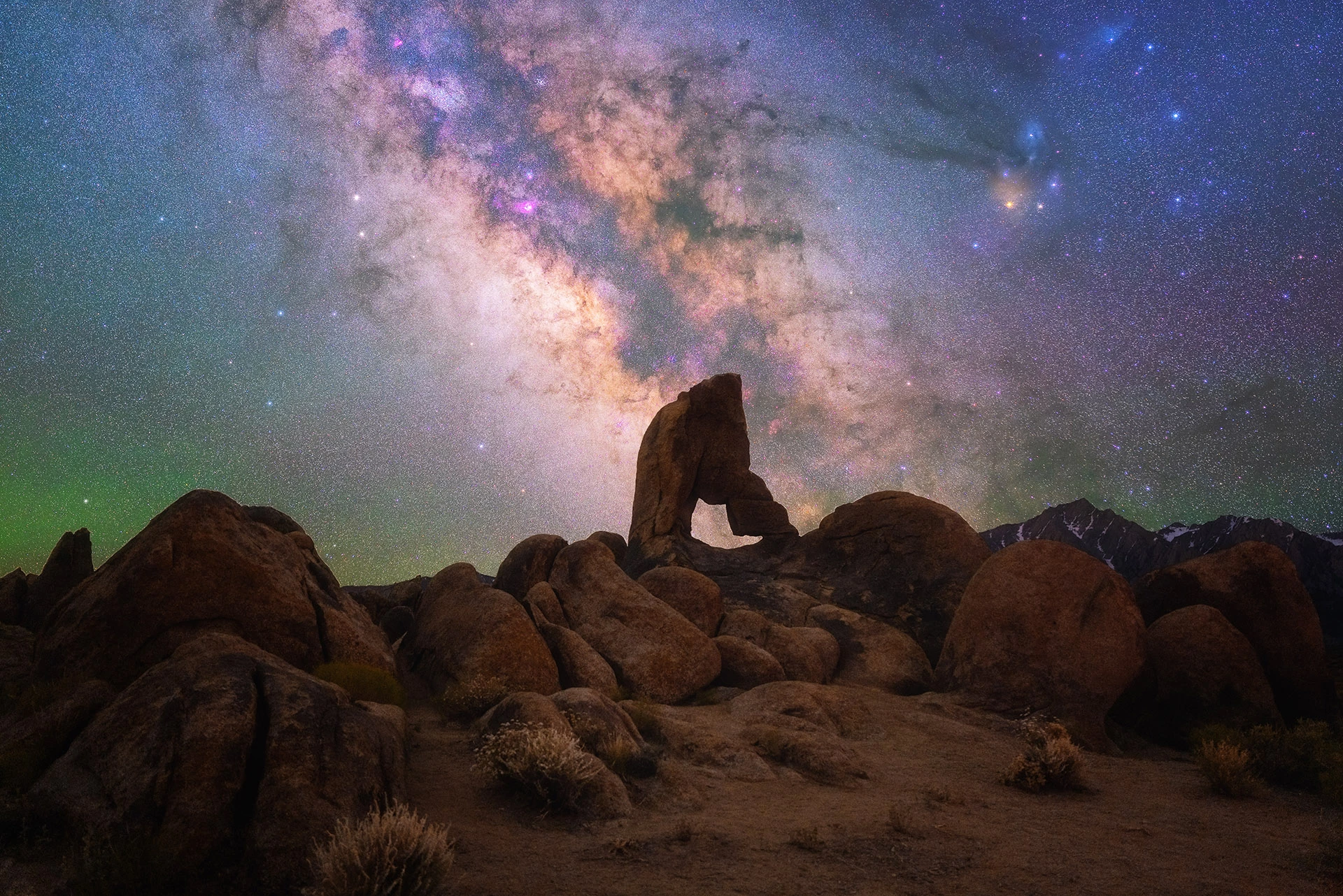 Desert Nights, shot in California, USA. The colorful night sky shines over the boulders of Alabama Hills.