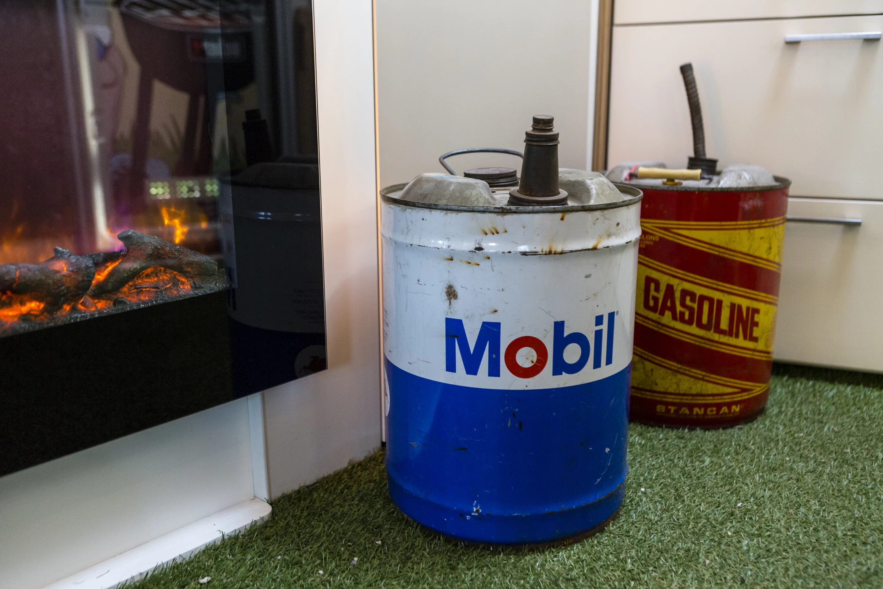 An electric ireplace tucked behind some manly decor