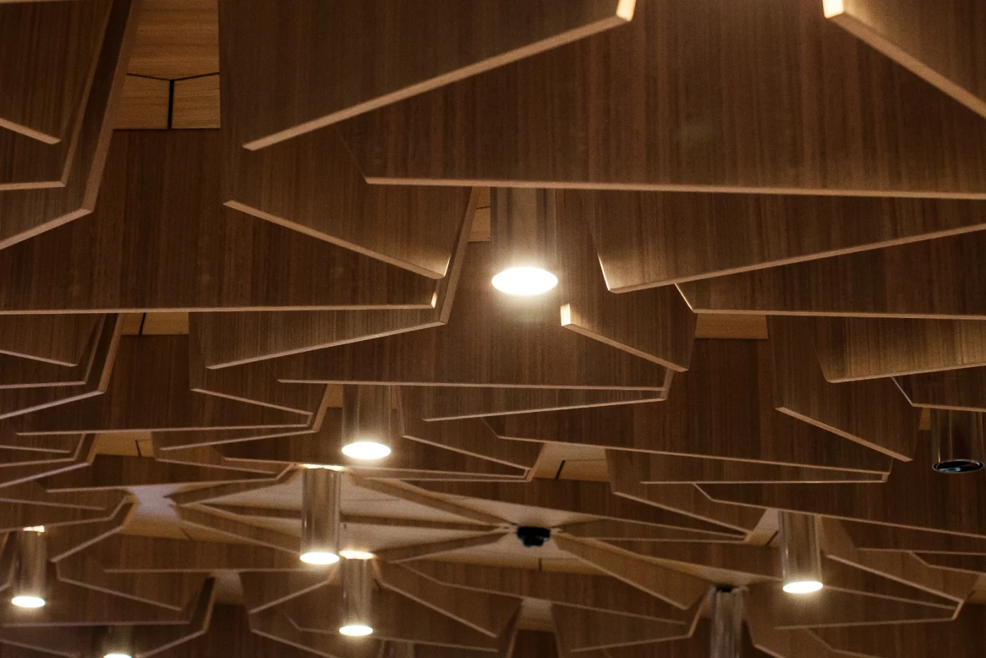 Under the base of the suspended studio are messy rows of vertical panels to further soften the acoustics