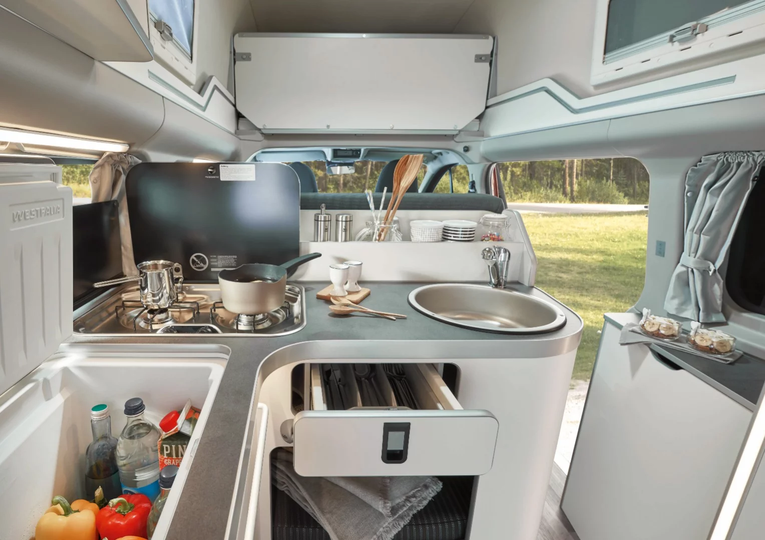The kitchen includes a dual-burner stove, sink and 40-L fridge