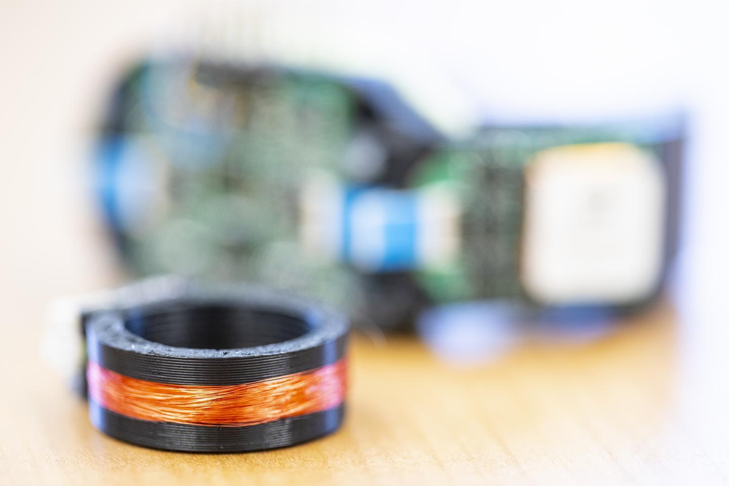 The AuraRing, with the wristband visible in the background – the copper wire is wrapped around the ring 800 times