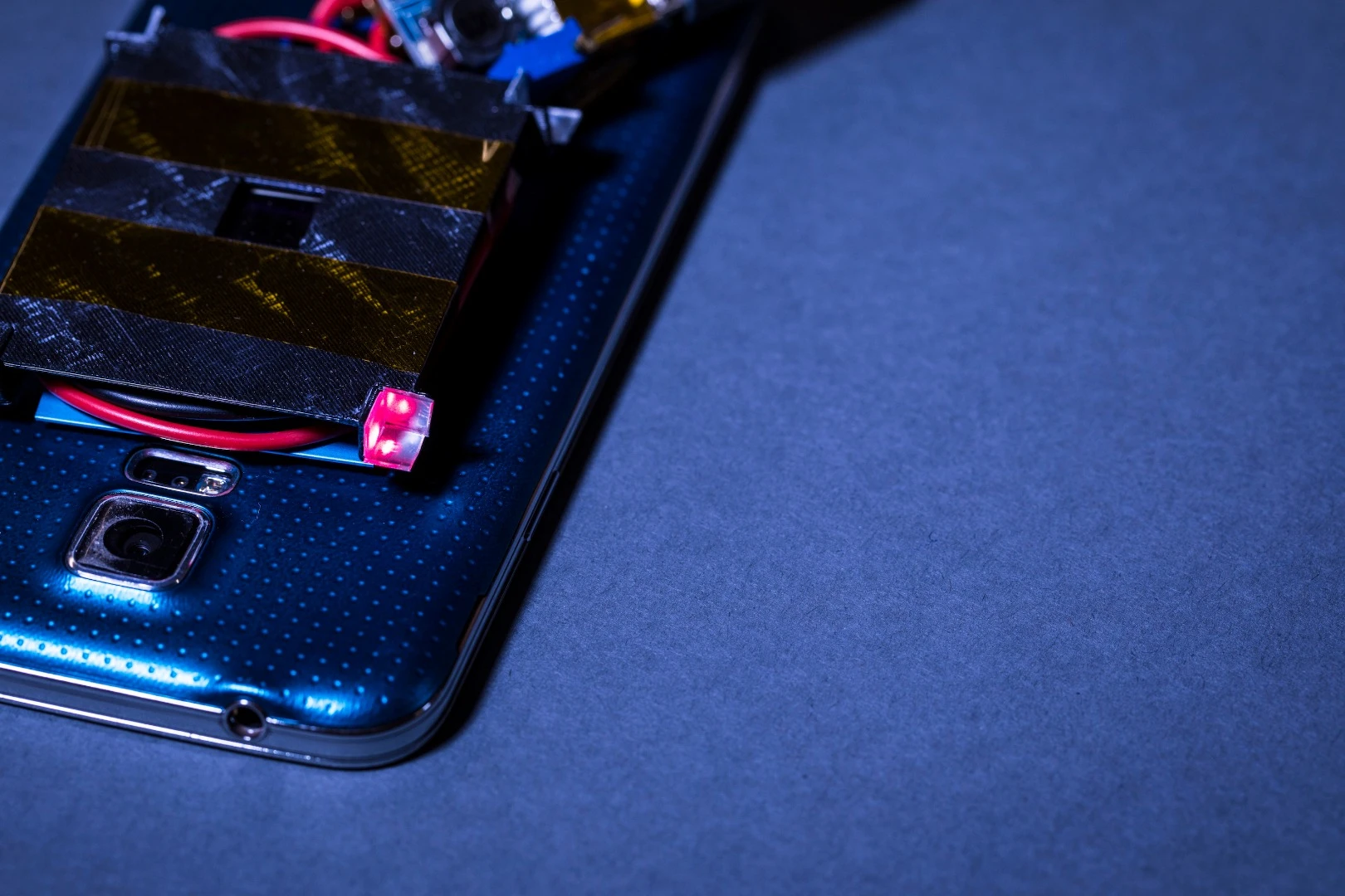 The red cube is one of the retroreflectors, which bounces the guard beam back to the emitter to prevent people from walking through the charge beam