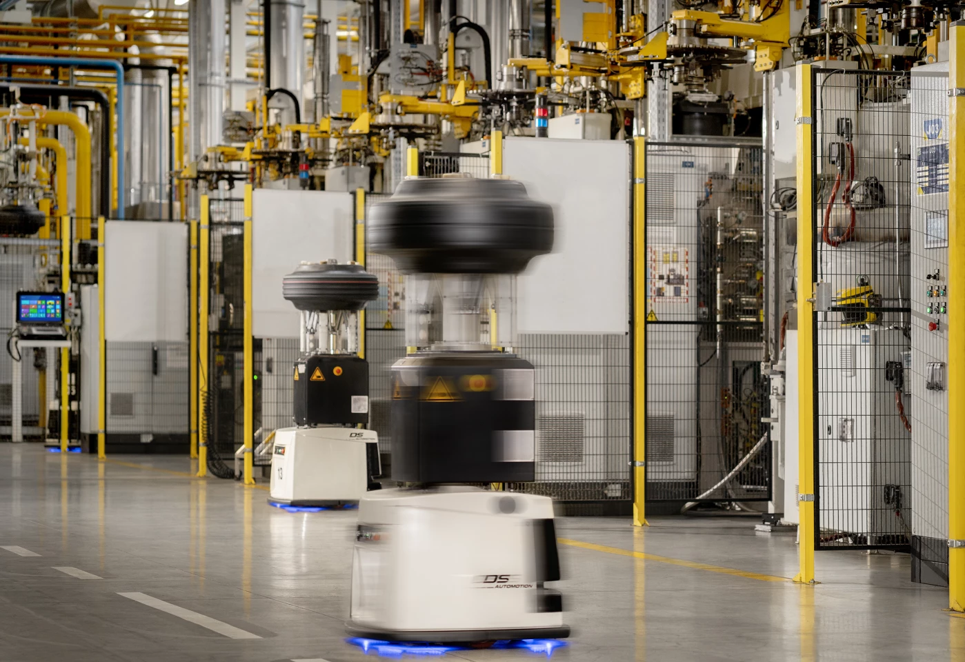 Autonomous robots carry unfinished tires around the largely automated Michelin tire factory in Cuneo, Italy