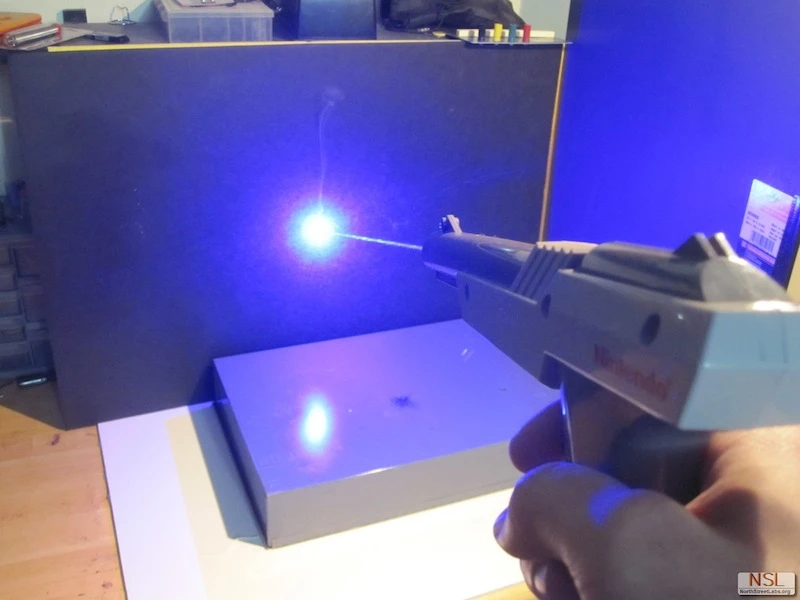 A hacker has retrofitted a classic NES Zapper with a powerful laser, resulting in a gun that is anything but a toy