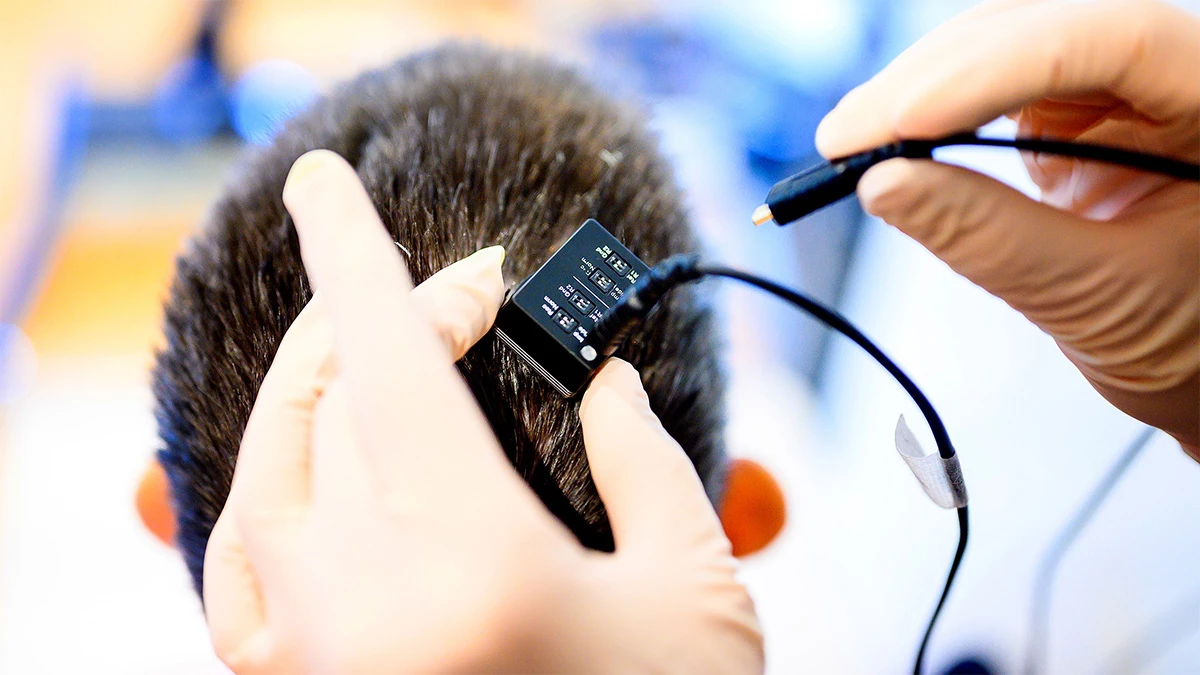 Researchers from UC Berkeley and UC San Francisco connect their subject Ann's brain implant to the voice synthesizer computer