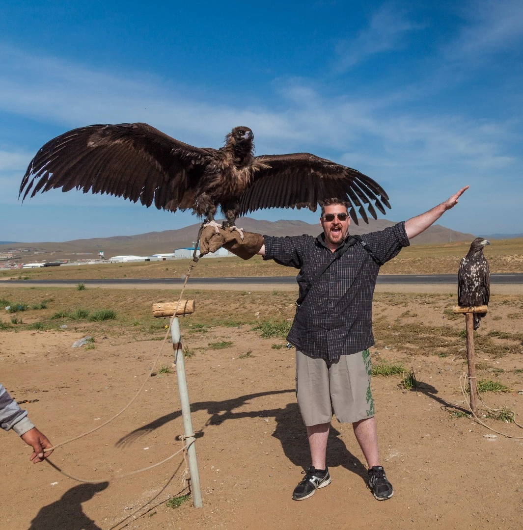 Loz Blain compares wingspans with a trained hunting eagle, outside Ulaanbaatar. Loz is found wanting.