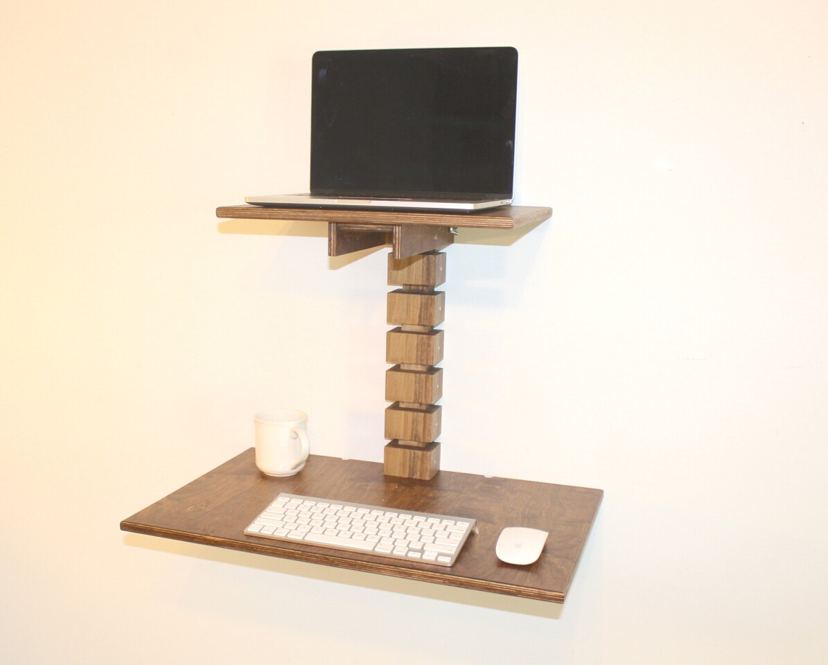 The Wall-Mounted Standing Desk is available in light or dark wood, and is priced at $245
