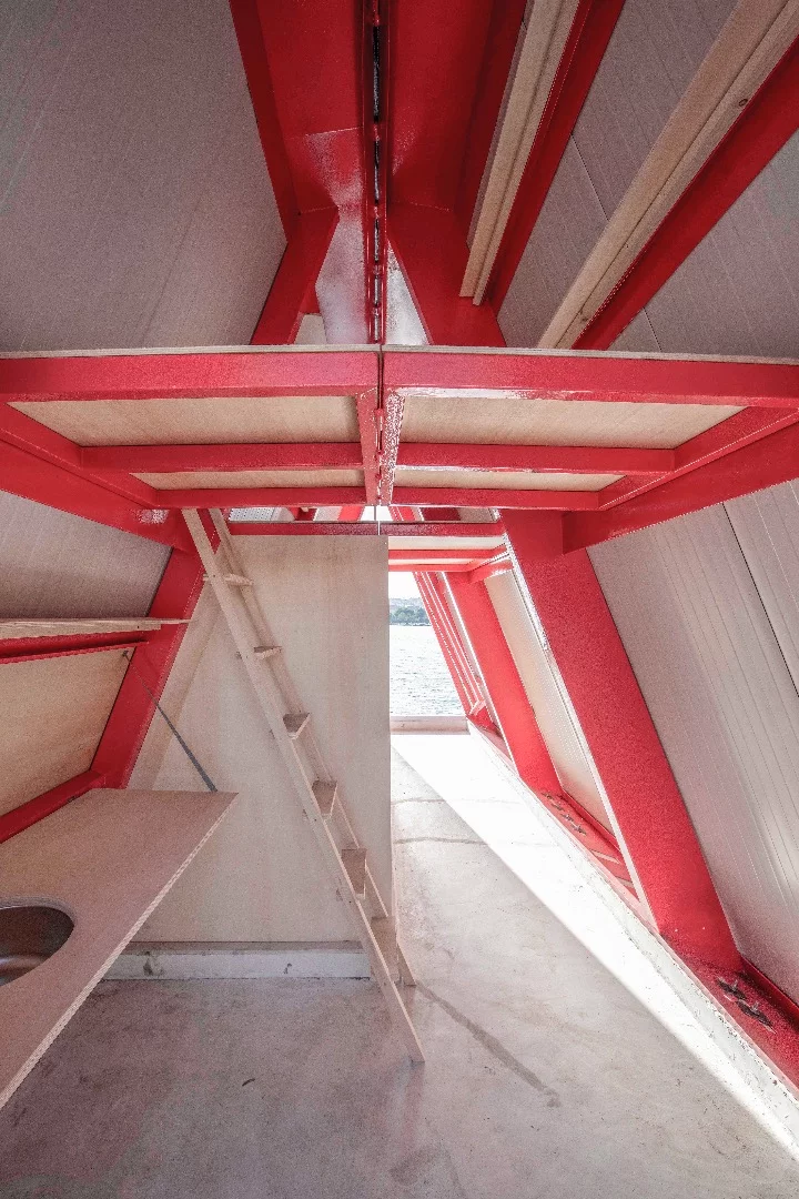 Fold&Float features a raised sleeping loft accessed by ladder