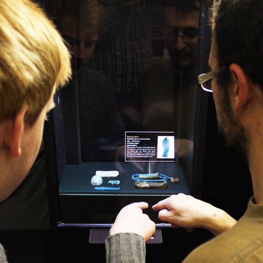 Sensors track both the location of the user's hand relative to the viewing side of the glass, along with a displayed object's location relative to the opposite side of the glass