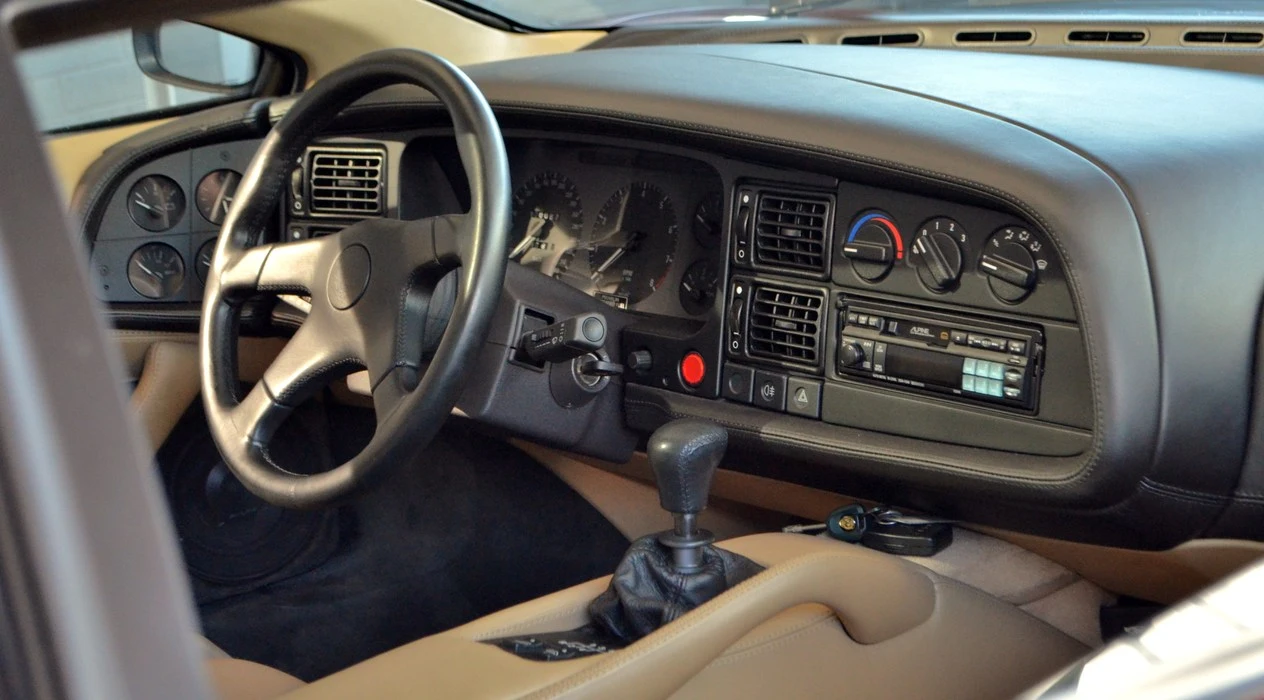 The dashboard wraps around the driver's door