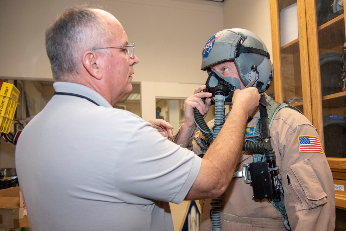NASA pilot Jim Less is assisted by life support as he is fitted with a Cobham designed VigiLOX pilot oxygen monitoring system
