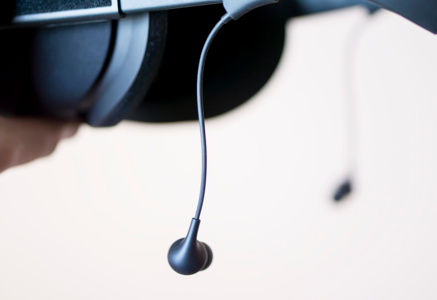 Oculus Earphones danging from Rift headset