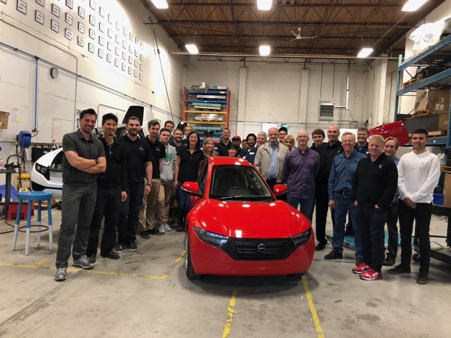 The Canadian Electra Meccanica team celebrates the arrival of the first Solo EV to come off the production line