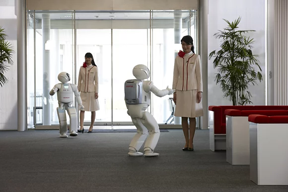 ASIMO robots greeting their guests