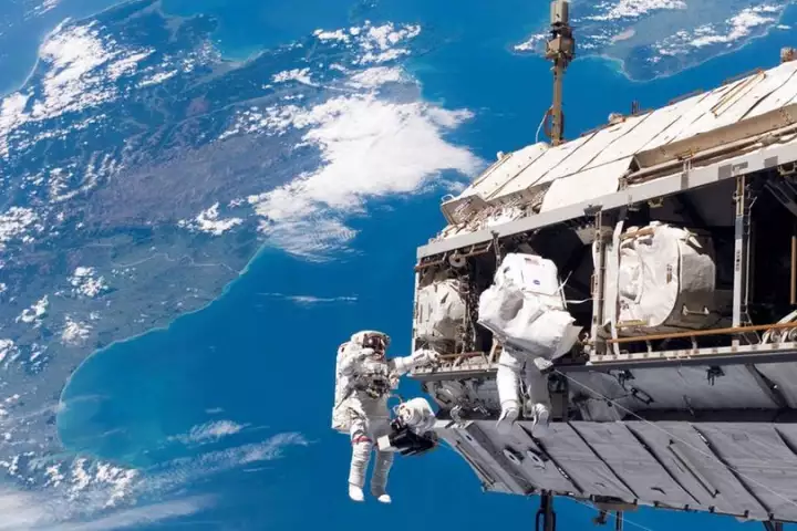 Astronauts toiling away on the International Space Station during an earlier spacewalk