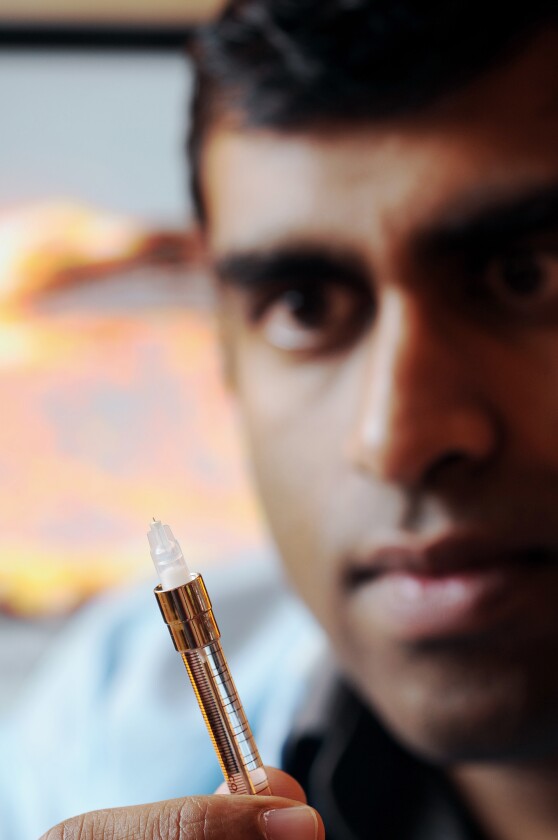 Researcher Samirkumar Patel displays a prototype microneedle