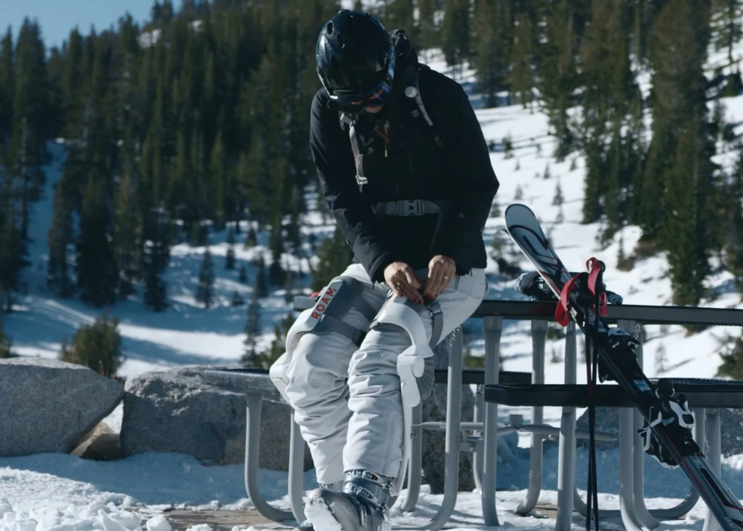 The Roam Robotics ski exoskeleton comprises a backpack connected to two support frames for the legs