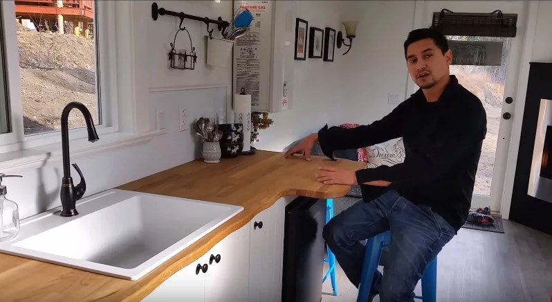 Robert sits at the cosy breakfast counter in the kitchen