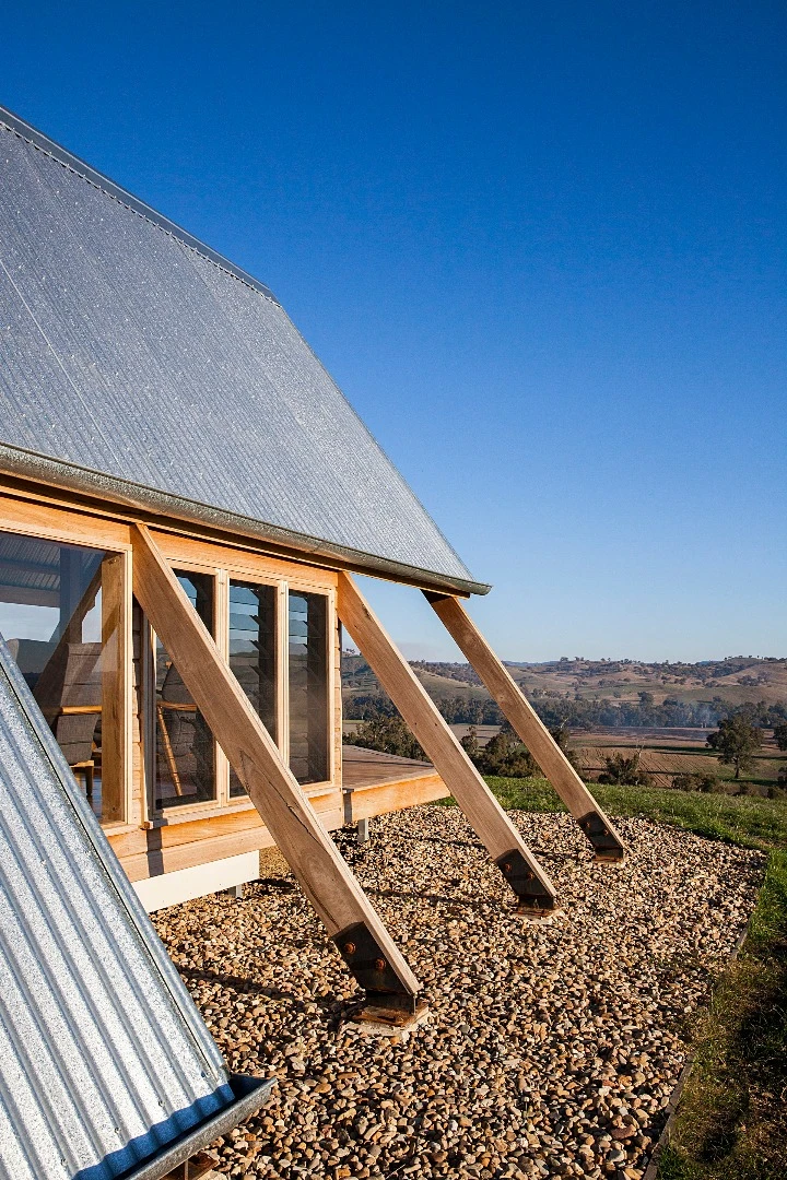 Inside the solar-powered JR's Hut is a bed for two, bathroom with a view and freestanding wood burner fireplace