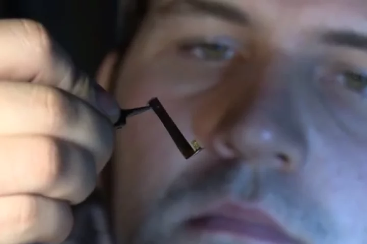 PhD student Christopher Pateman with one of the NGCs (tiny yellow object at center) (Photo: University of Sheffield)