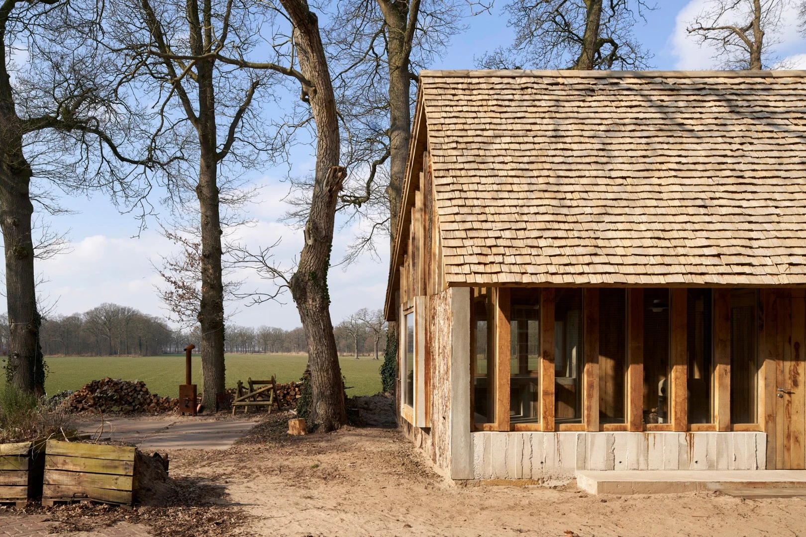 Deteriorating, century-old oak trees destined for the scrapheap have been worked into a lovely barn in the Netherlands