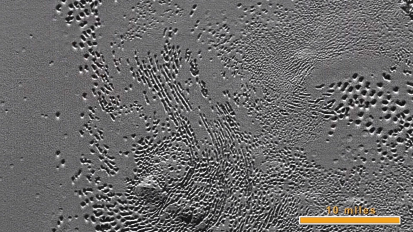 Pitted and hummocky ice plains in the southern reaches of Sputnik Planum
