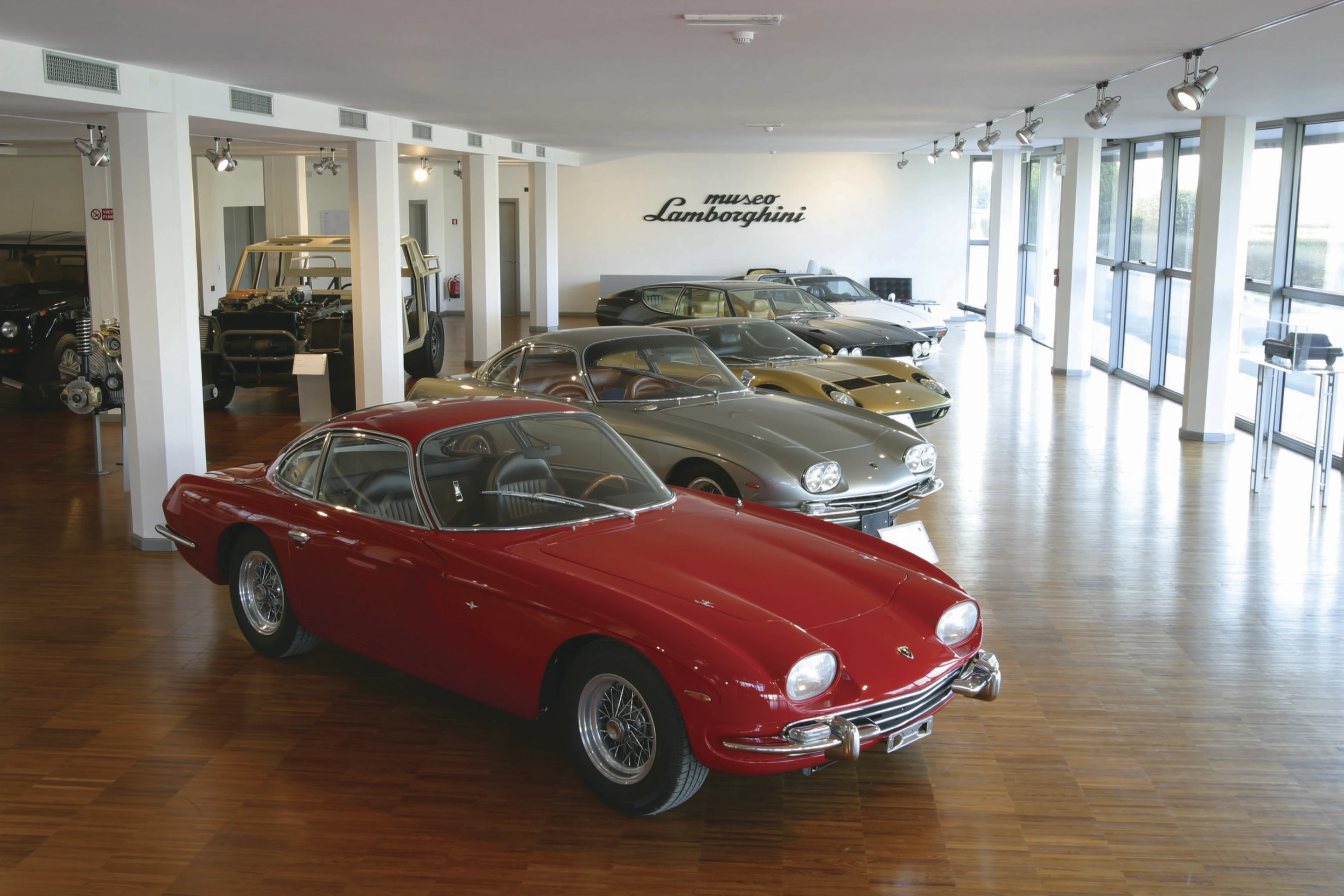 Museum second floor, more historic Lambo's reside on hardwood floors while a stripped down LM bares its framework