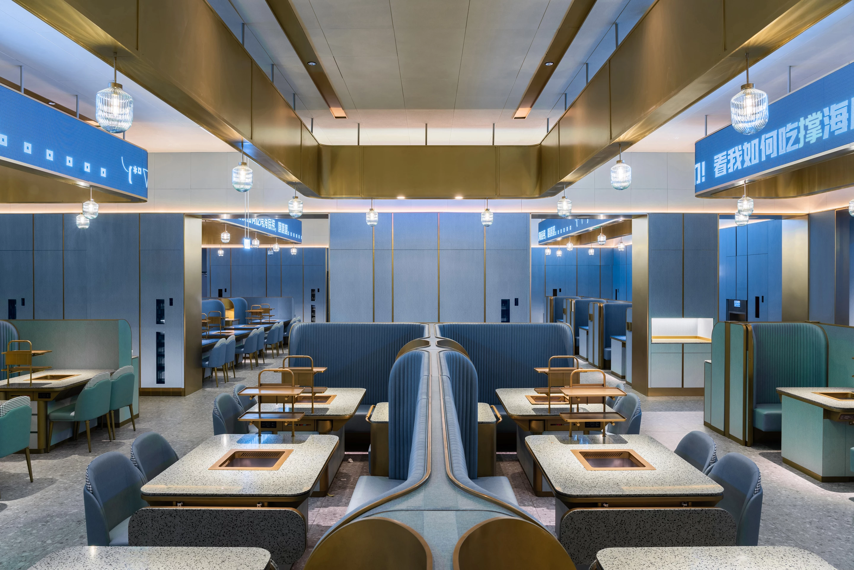 New version of Haidilao was designed by Vermilion Zhou Design Group and is located in China. The renovation focused on improving efficiency for the restaurant and adding softer colors and materials, as well as automated systems