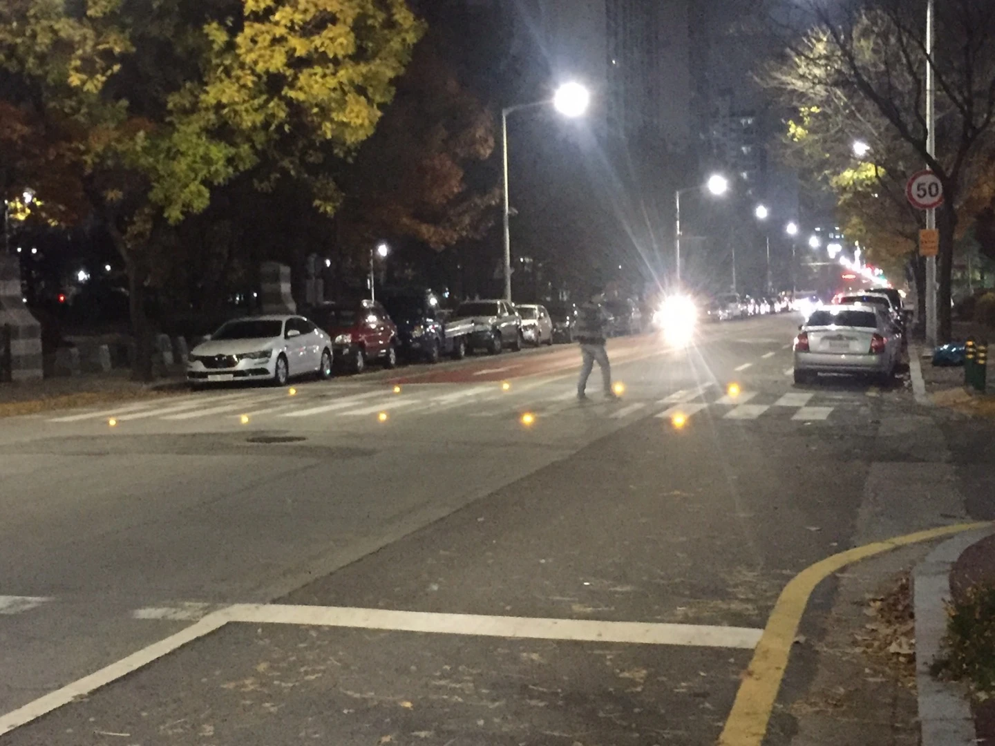 The crosswalk features warning LEDs embedded in the road
