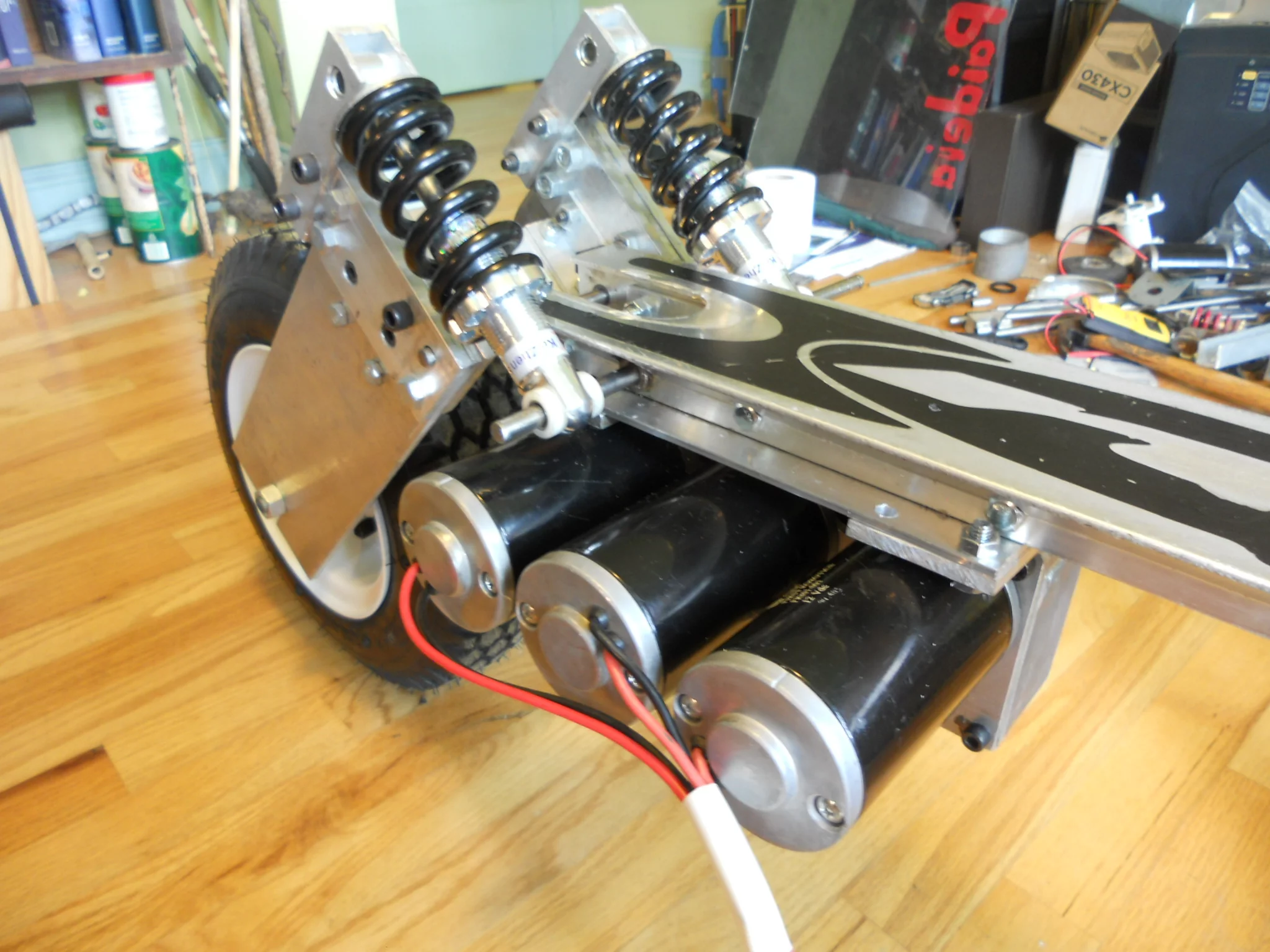 The electric motor setup in place underneath the scooter's deck