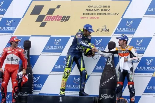 An interesting moment for the two former arch-rivals as eyes momentarily meet as Rossi shakes hands with Biaggi. Oncethe fiercest of enemies, the venom has slowly subsided in the relationship. Capirossi completed the all-Italian podium and was clearly eve