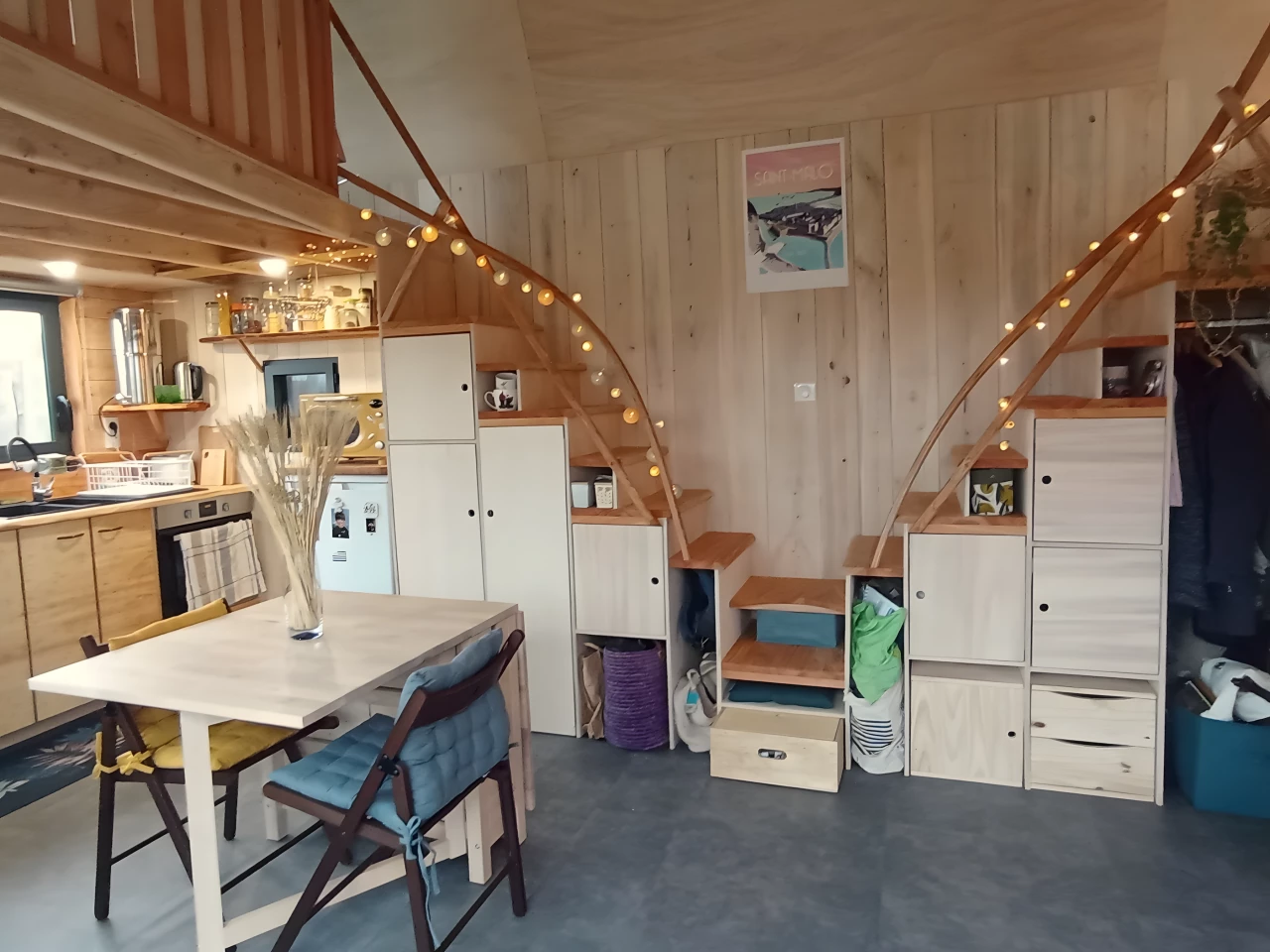 The Tiny XXL's two bedrooms are reached by separate storage-integrated staircases that have attractive wooden handrails