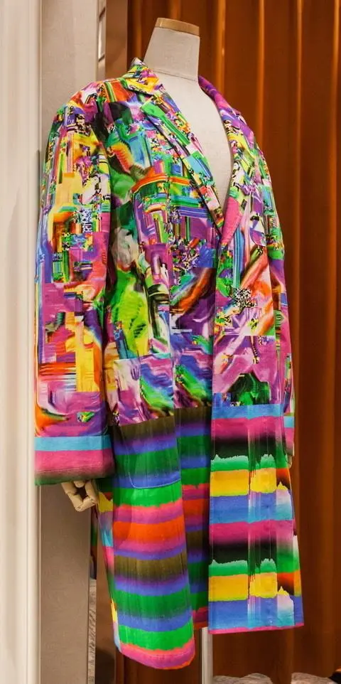 The Glitch Coat by Nukeme is a glitch design printed onto a plastic lab coat