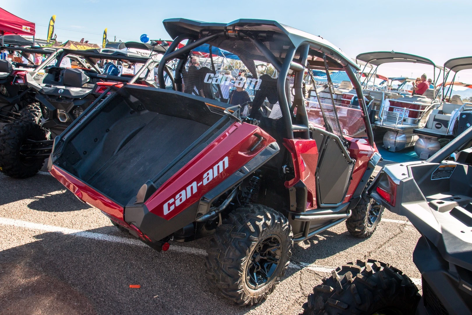 The Can Am Commander. Both sport and utility with a dual level cargo area featuring a tilt-assist cargo bed, shown here in action