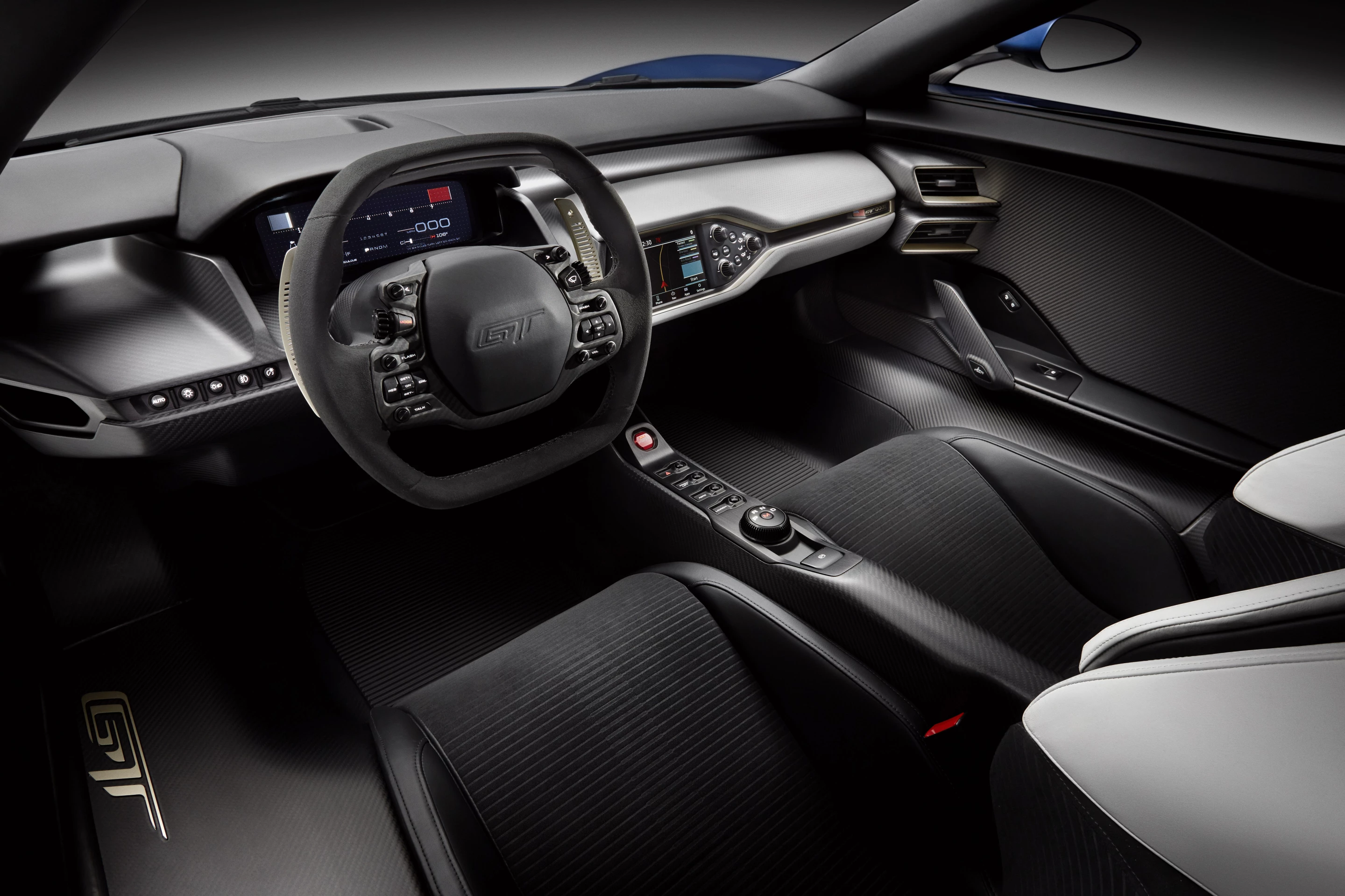 The two-seat cockpit is accessed by upward-swinging doors, and features driver and passenger seats integrated directly into the carbon fiber passenger cell. This configuration significantly reduces seating hardware and weight, and provides a consistent and Ford claims the arrangement offers a “direct sensory connection to the chassis.” The fixed seating means that Ford has employed adjustable pedals and steering column to accommodate a very wide range of driver statures.