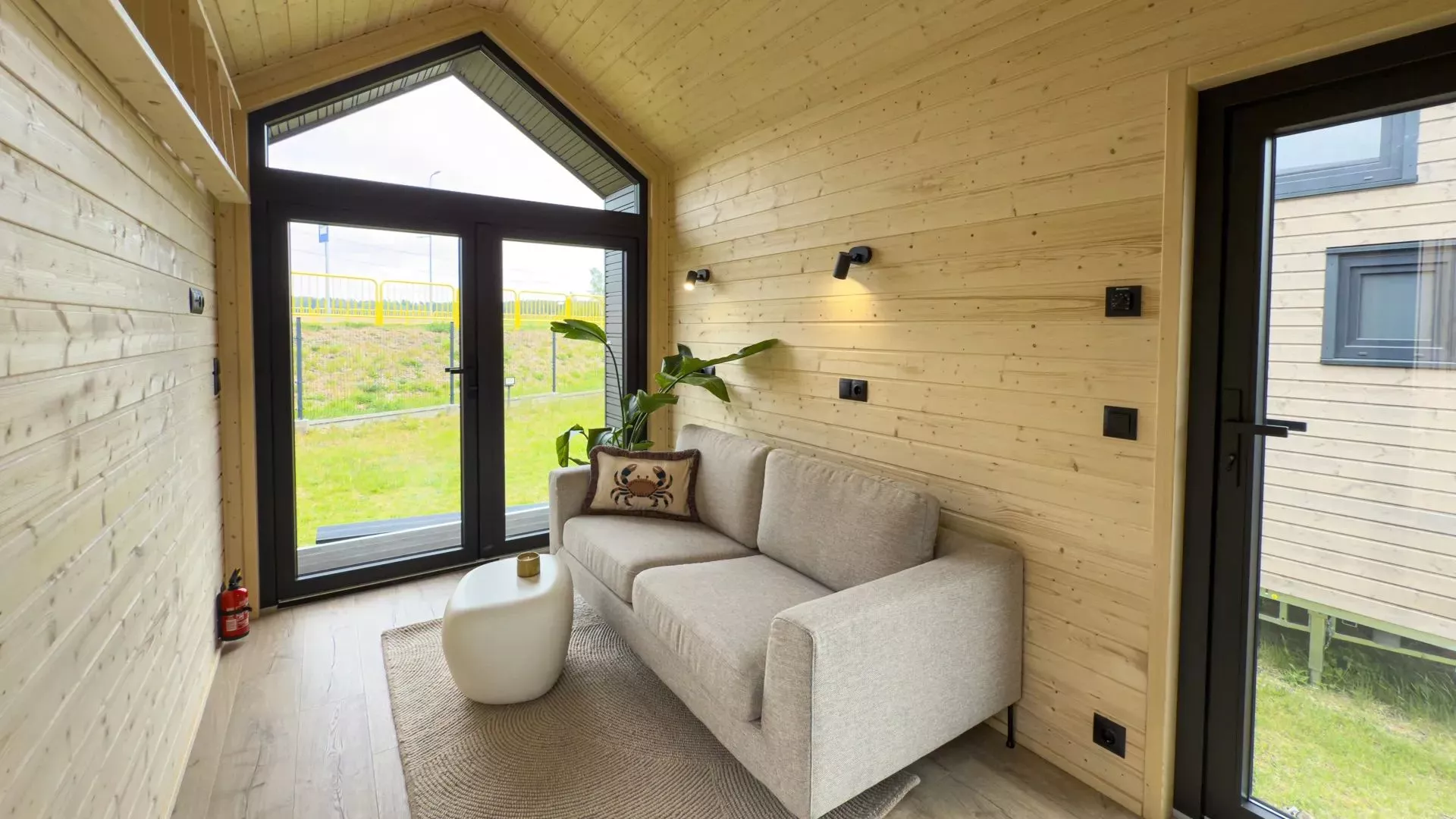 The lounge space in this promo shot has been furnished with a double sofa and small coffee table