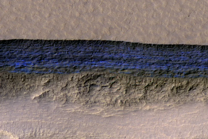 The blue section (artificially colored) represents the exposed face of an underground ice sheet on Mars, at a scale of about 500 m (1,650 ft) wide