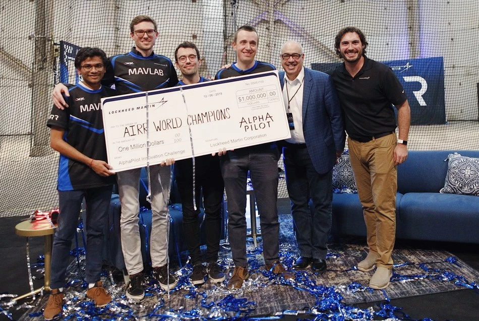 Team MAVLab with its winnings, presented by Dean Acosta from Lockheed Martin, who sponsored the competition