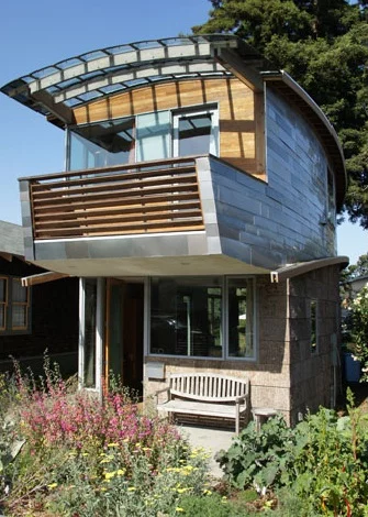 The curved exterior walls give the impression that the house is smaller and shorter than an average two-story home