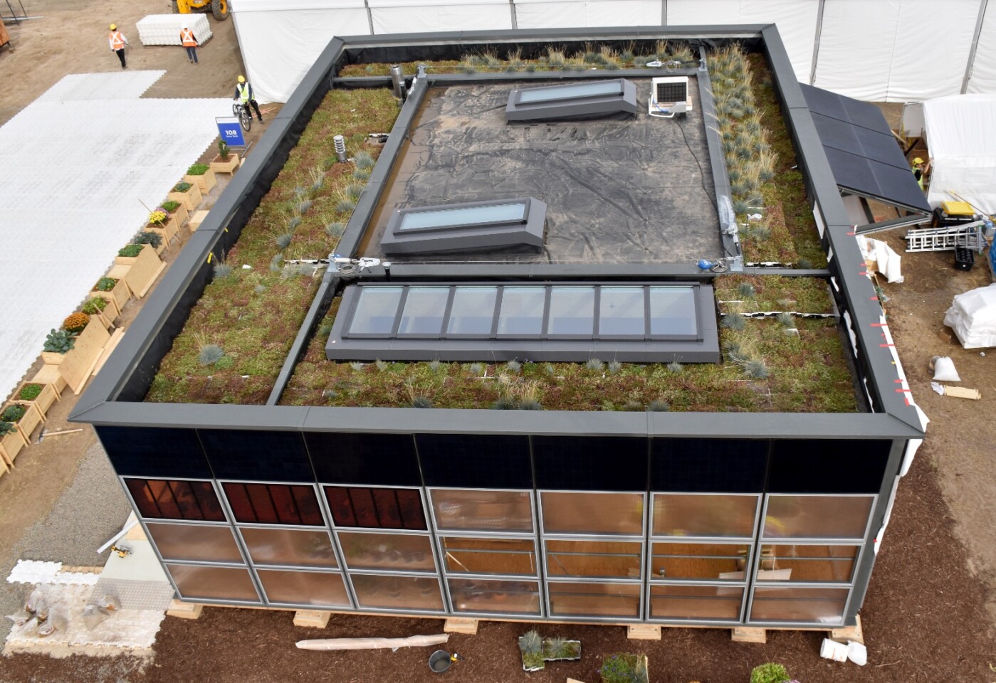 The NeighborHub's roof collects rainwater to grow food, as well as plants chosen to attract bees. Some of the water is also used for laundry