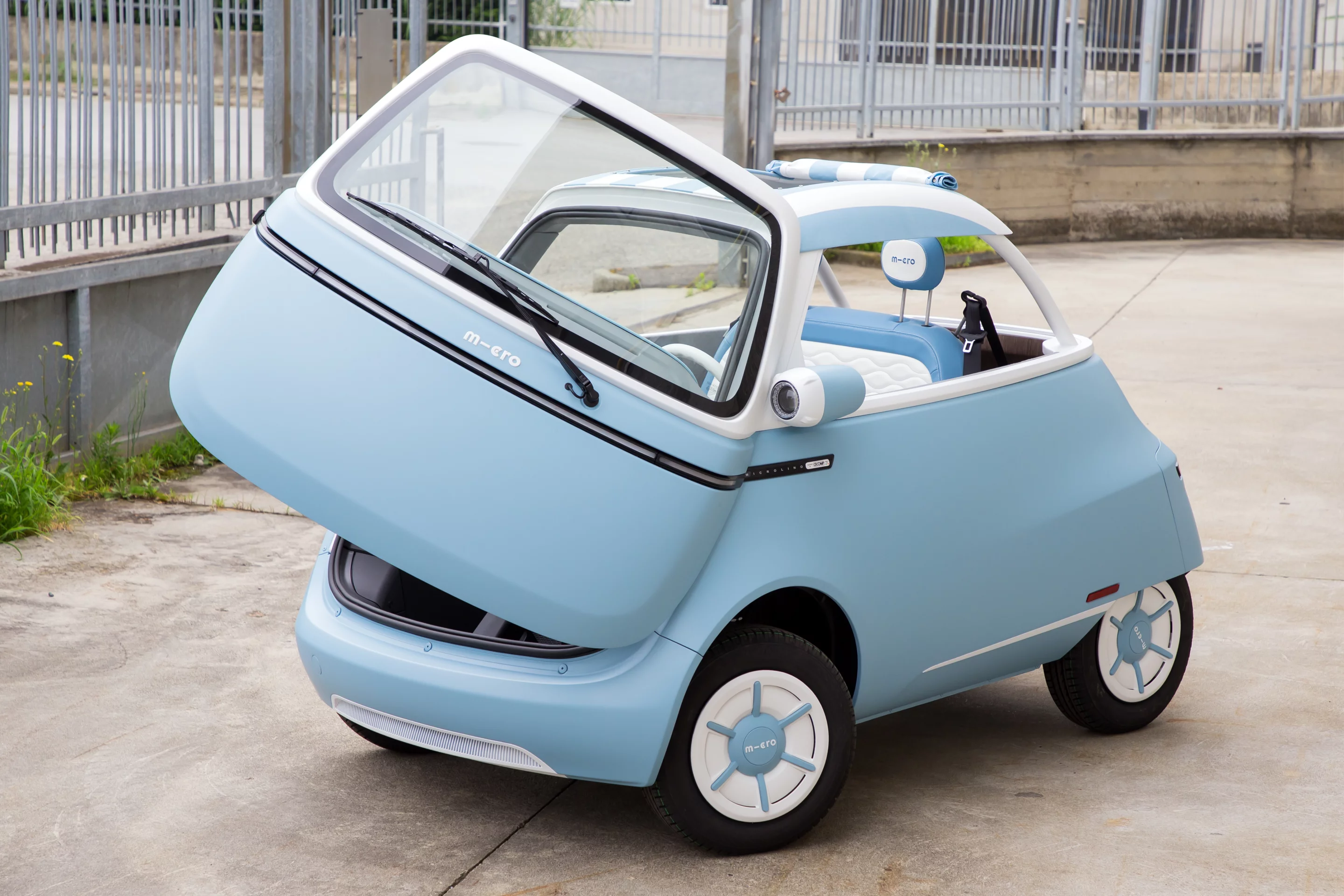 The Microlino Spiaggina electric micro car features a fabric sunroof and open back/sides