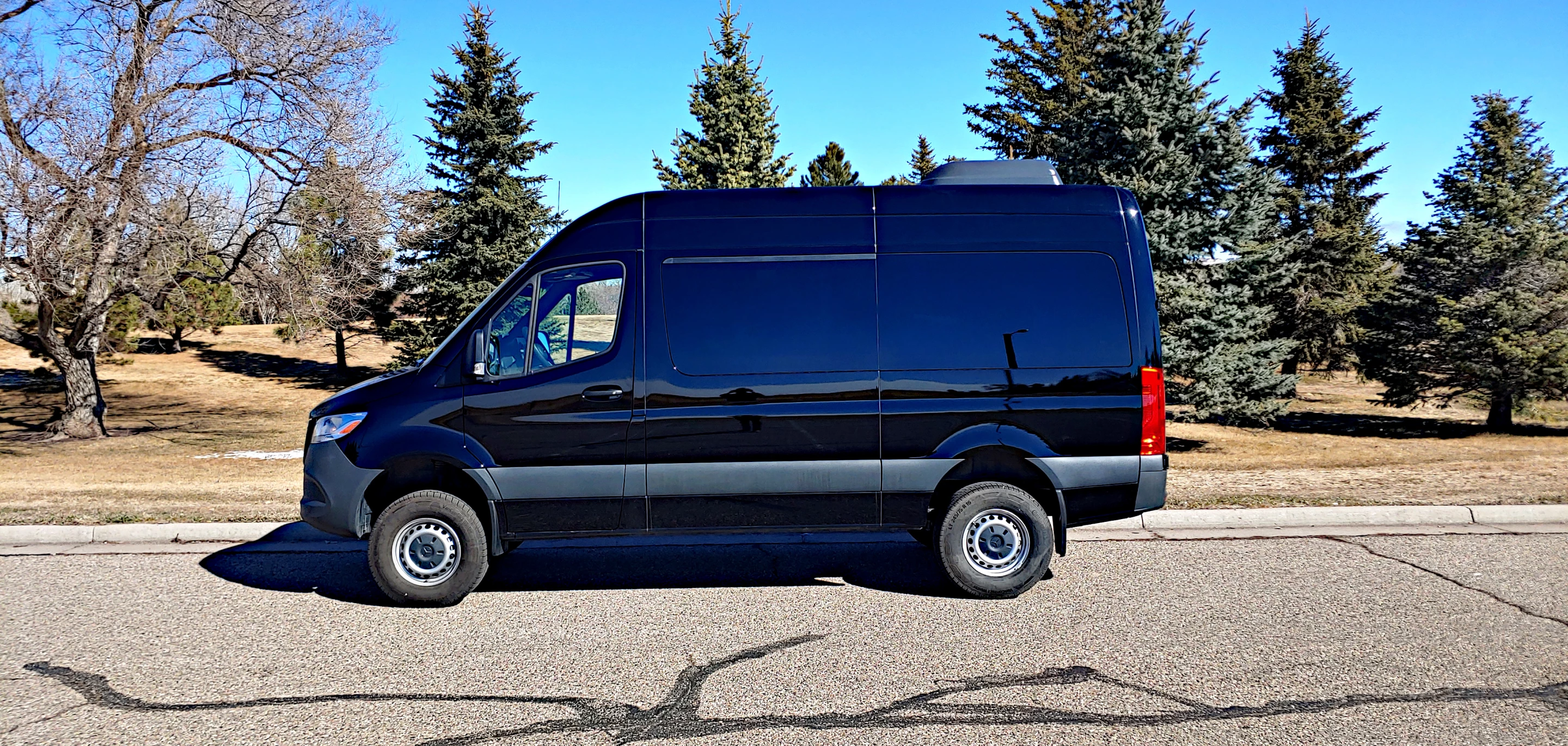 The Sprinter's sliding door, which is curbside, opens to reveal the three rows of benches inside