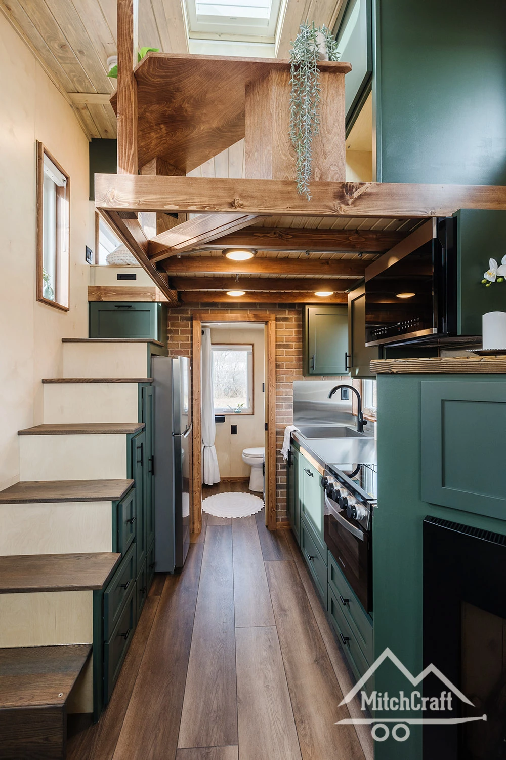 Much of the available floorspace in Nicole's 16 x 8 Tiny Home is taken up by its relatively spacious and well-stocked kitchen area