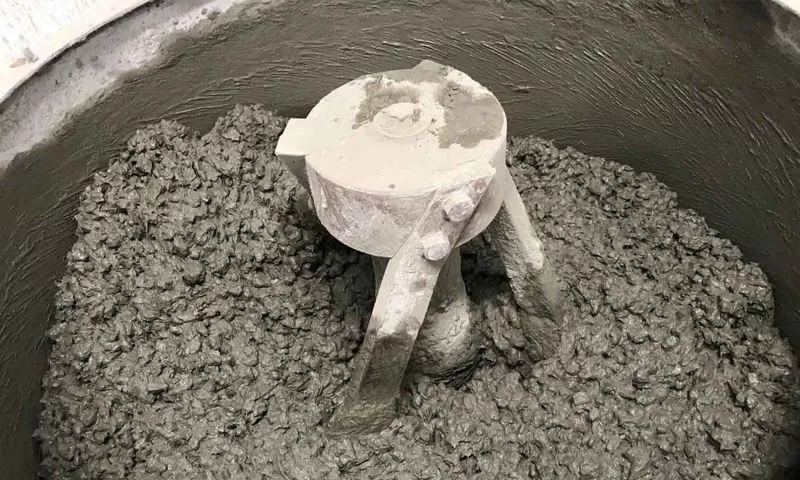 Particles of ground-up tires are mixed into the wet concrete