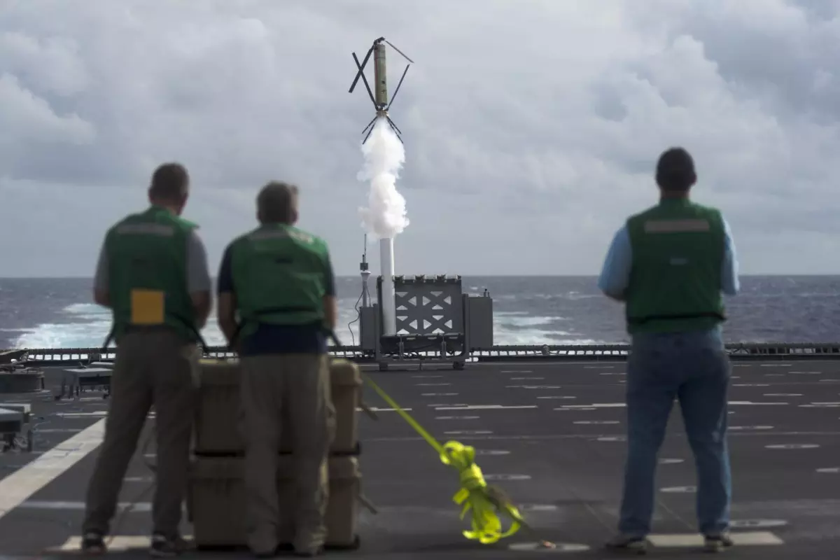 Civilian contractors from the Office of Naval Research conduct a test on the Nomad drone system aboard the littoral combat ship USS Coronado