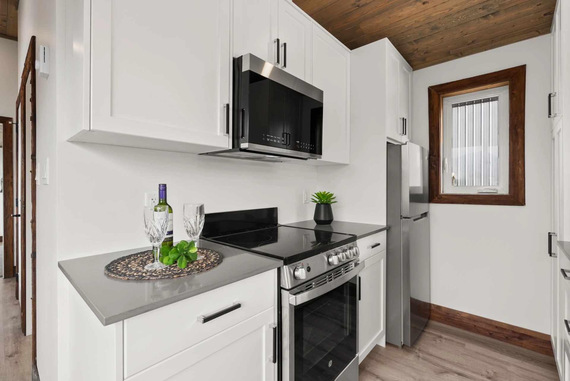 The Cypress' kitchen includes an oven with a stove, a dishwasher, and a fridge