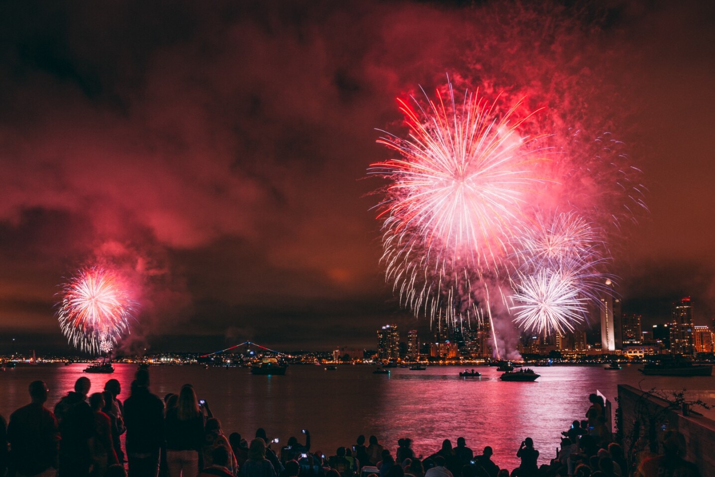 Crowd foreground, lake midground, city background. Lots of smoke in the sky for the fireworks to reflect off. Nice shot!Nikon D800, ISO 100, f/8.0, 3.2 seconds, 20mm